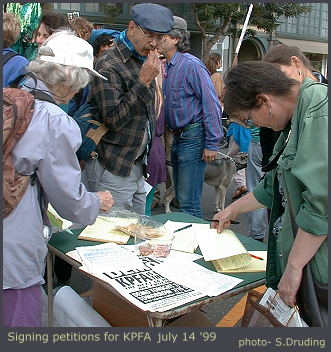 signing petitions at KPFA demonstration