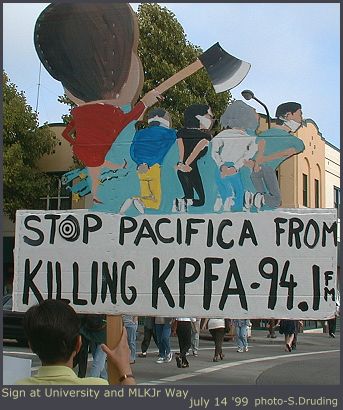 Figures on KPFA sign - july 14, 1999