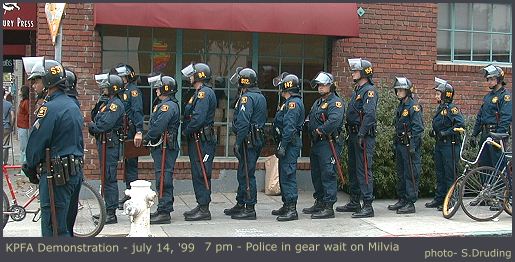 Police in riot helmets wait around corner on Milvia at University - 7 pm
